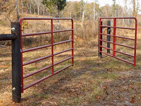 A red epoxy coated double swing corral gate.